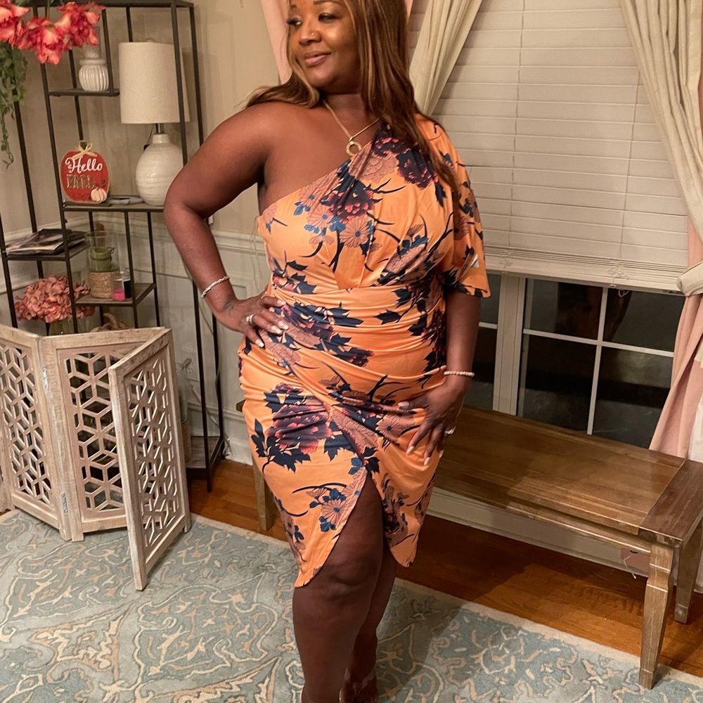 One shoulder apricot Polynesian cocktail dress with purple flowers.